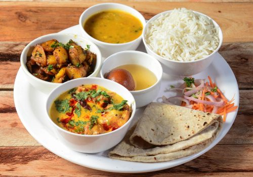 indian-veg-rajasthani-thali-food-platter-consists-variety-veggies-lentils-sweet-dish-snacks-etc-selective-focus_726363-570